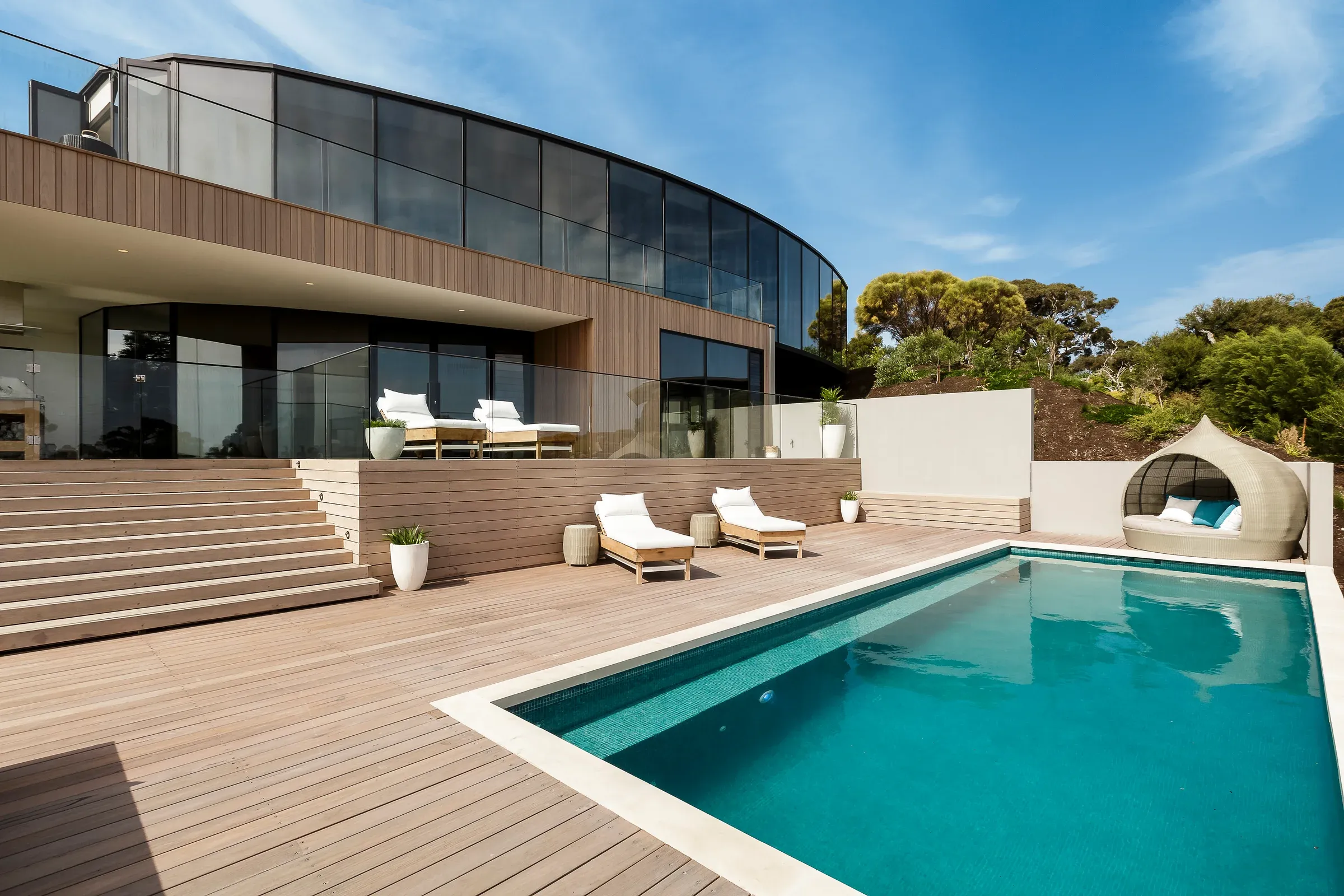 Terrasse mit breiten Stufen und Pool an einem modernen Wohnhaus
